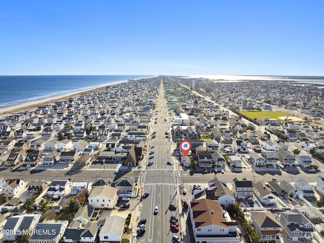 drone / aerial view with a water view and a view of the beach