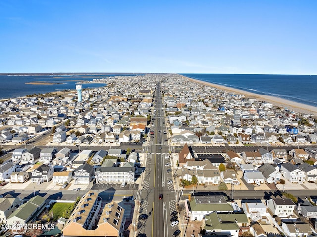 birds eye view of property featuring a view of the beach and a water view