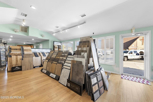 interior space featuring light hardwood / wood-style floors and vaulted ceiling