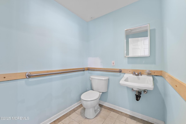 bathroom featuring tile patterned floors, toilet, and sink