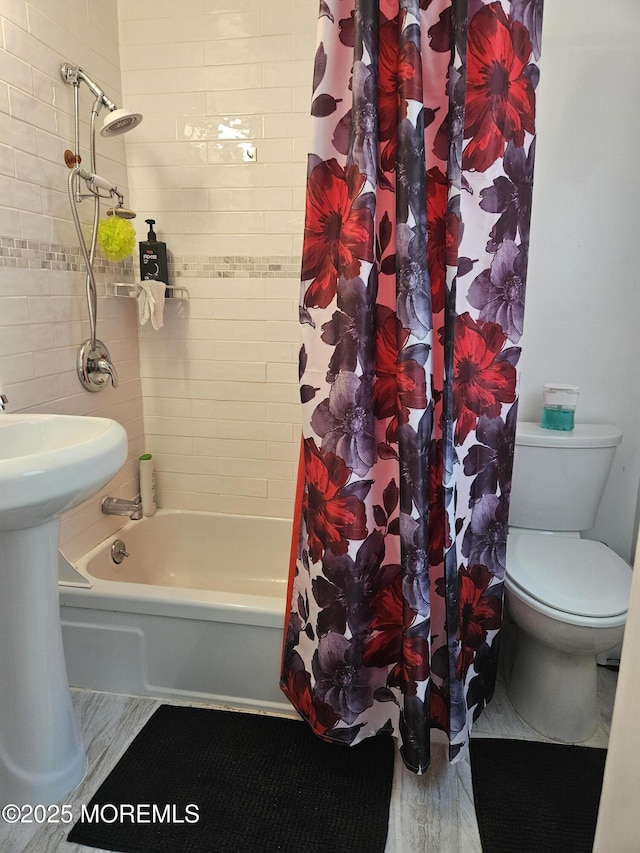 bathroom with shower / bath combo and toilet