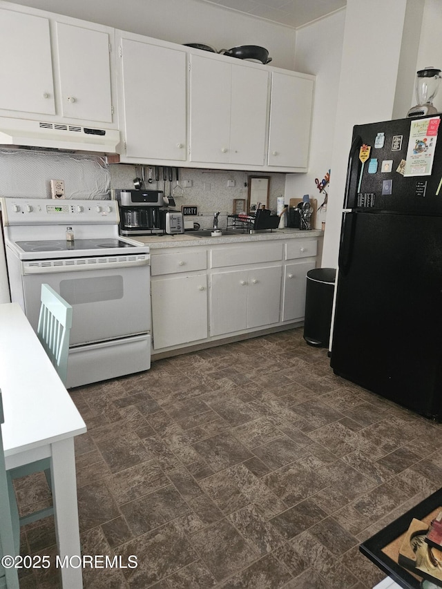 kitchen with white electric range, black fridge, backsplash, extractor fan, and white cabinets