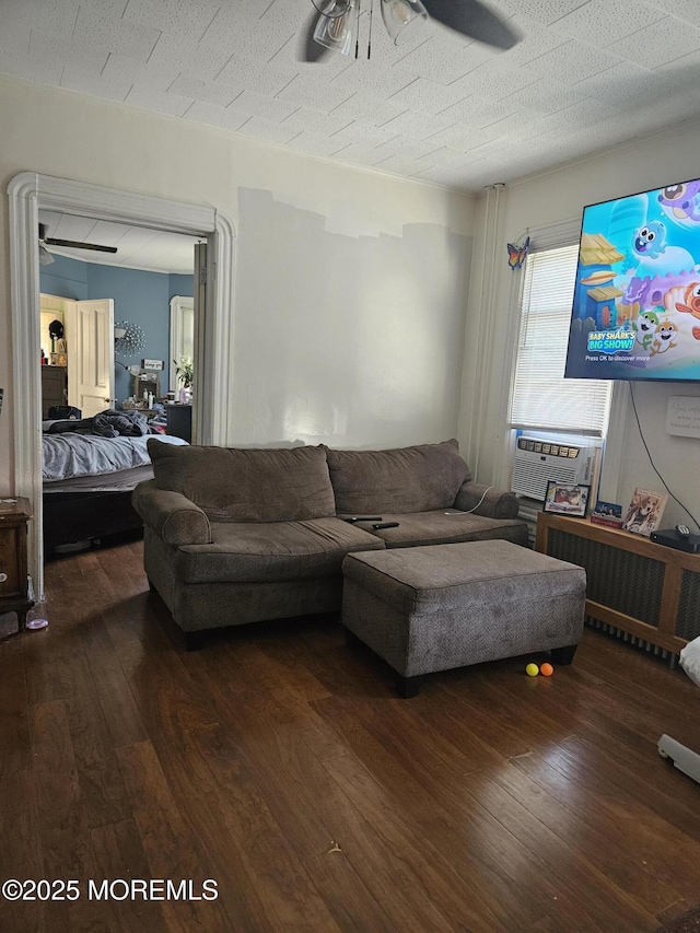 living room featuring radiator heating unit, dark hardwood / wood-style floors, and ceiling fan