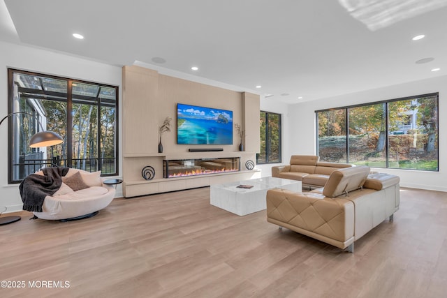 living room with plenty of natural light and light wood-type flooring