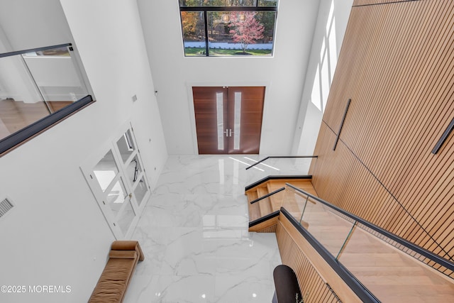 foyer featuring a towering ceiling