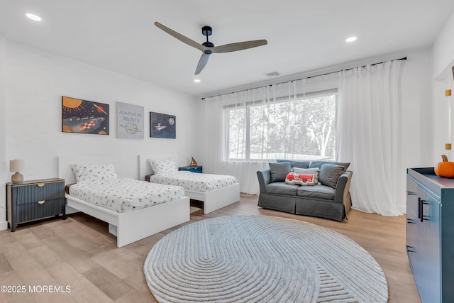 bedroom with ceiling fan and light hardwood / wood-style floors