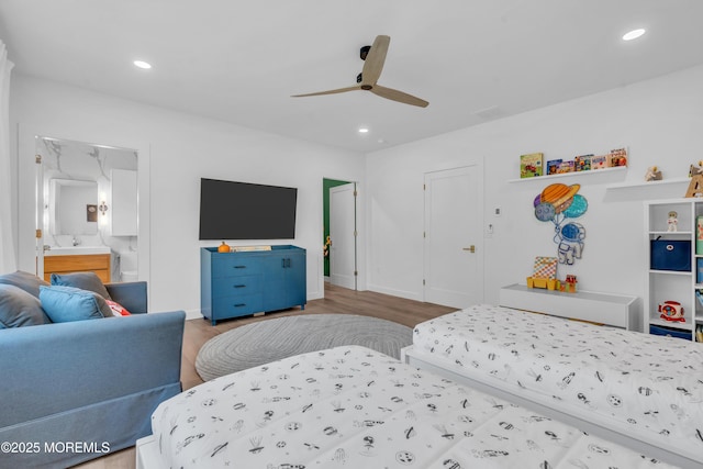 bedroom with hardwood / wood-style flooring, ceiling fan, and ensuite bathroom