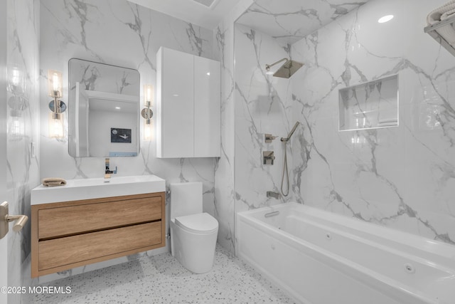 full bathroom featuring vanity, toilet, washtub / shower combination, and tile walls