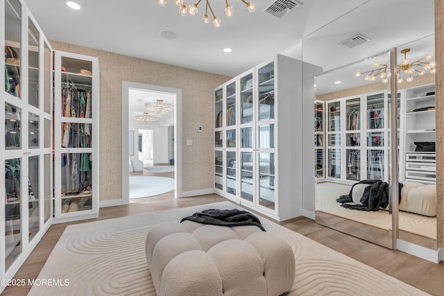 interior space with wood-type flooring and an inviting chandelier