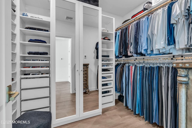 walk in closet featuring hardwood / wood-style floors