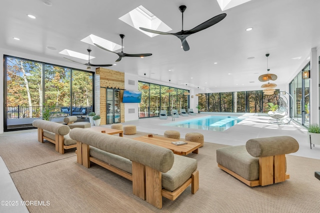 view of swimming pool featuring a skylight and ceiling fan