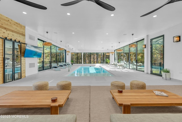 view of swimming pool featuring ceiling fan