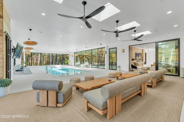 view of swimming pool with ceiling fan and a skylight