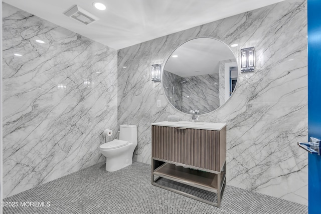 bathroom featuring tile patterned flooring, vanity, and toilet