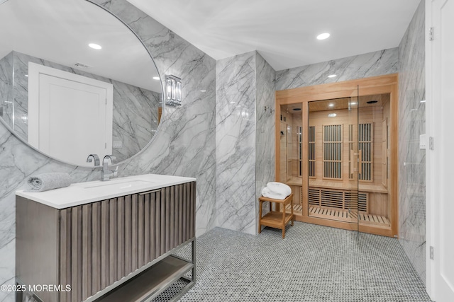 bathroom with vanity, tile patterned floors, and tile walls