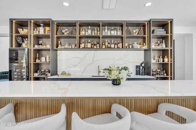 bar with light stone counters and sink