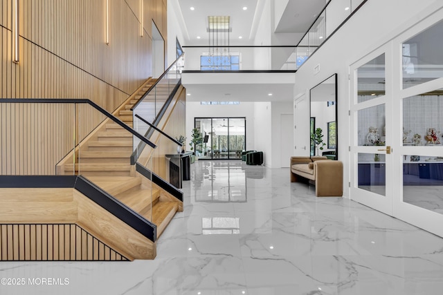 staircase with a high ceiling and french doors