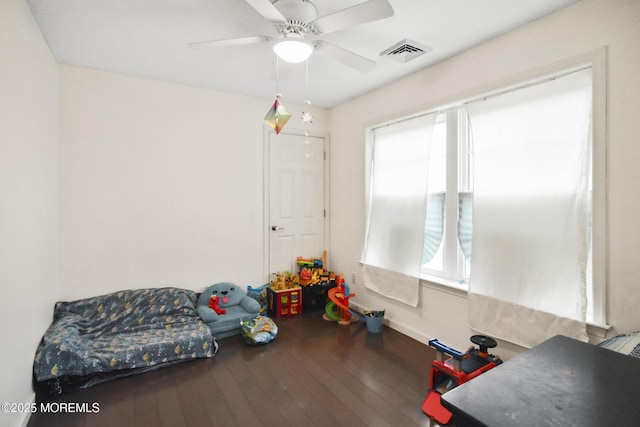 living area featuring ceiling fan and hardwood / wood-style floors