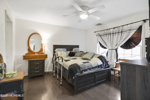 bedroom with ceiling fan and dark wood-type flooring