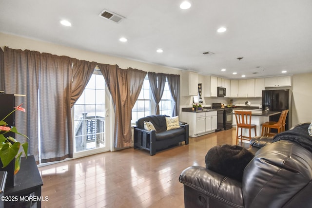 living room with light hardwood / wood-style flooring