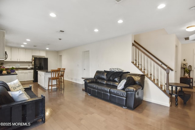 living room with light hardwood / wood-style flooring