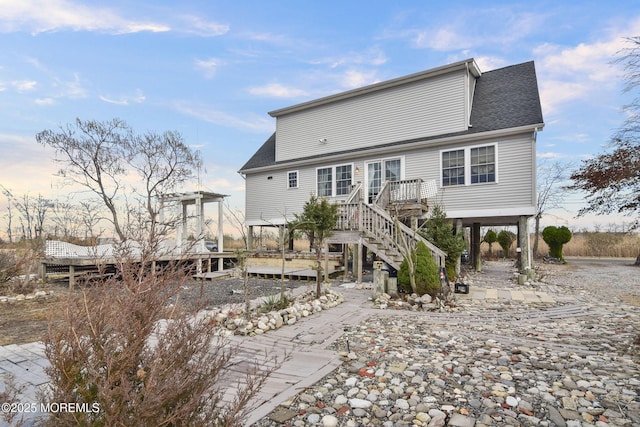 rear view of house featuring a deck