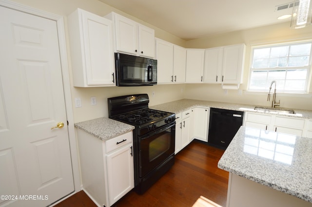 kitchen featuring black appliances, white cabinets, and sink