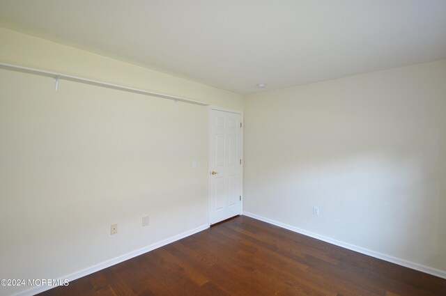 unfurnished room featuring dark hardwood / wood-style flooring