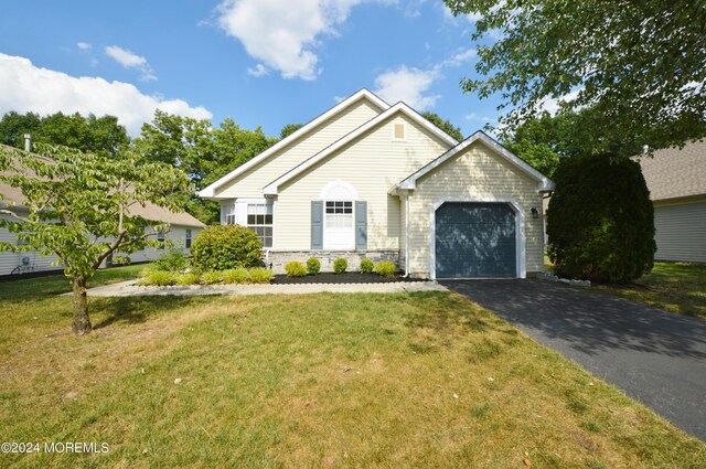 view of front of home featuring a garage and a front lawn