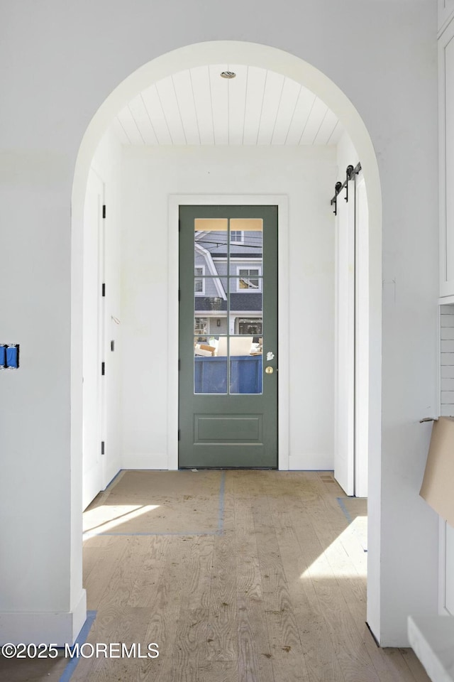 entrance foyer featuring a barn door and light hardwood / wood-style flooring