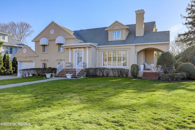 view of front of house with a garage and a front yard