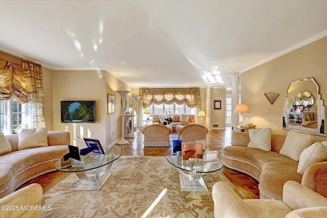 living room with ornate columns, ornamental molding, and a healthy amount of sunlight