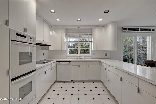 kitchen with white appliances and white cabinets