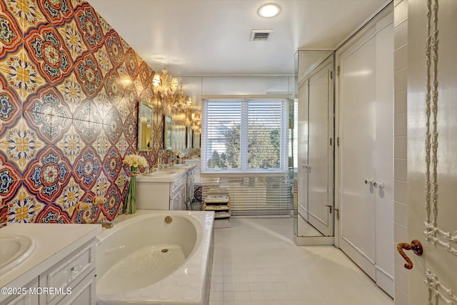 bathroom featuring vanity, a tub, and tile walls