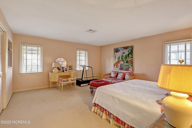 carpeted bedroom featuring multiple windows