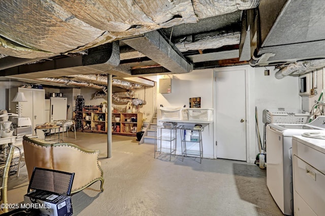 basement with white refrigerator and independent washer and dryer