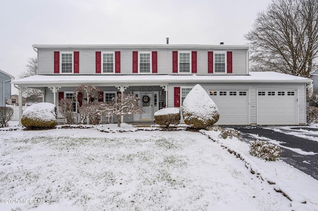 front of property featuring covered porch and a garage