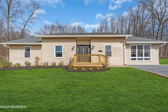 ranch-style house with a wooden deck and a front lawn