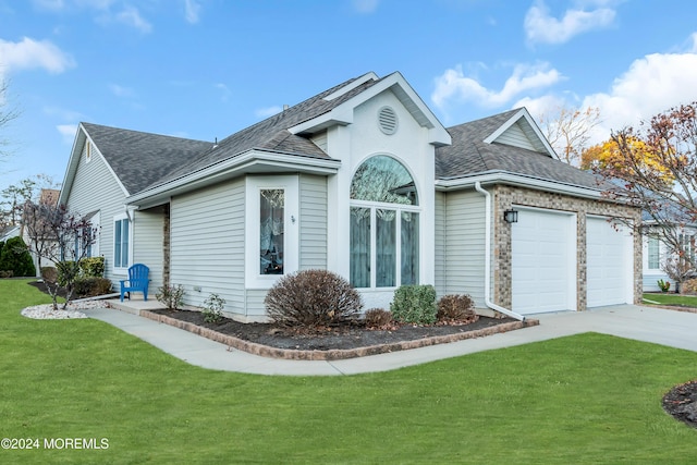 view of front of house with a garage and a front yard