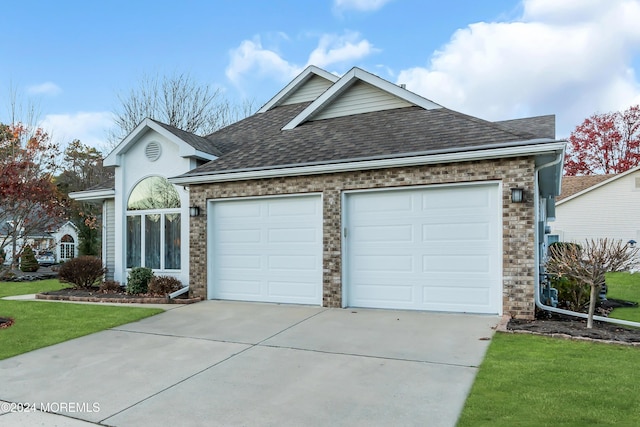 view of front facade with a front yard and a garage