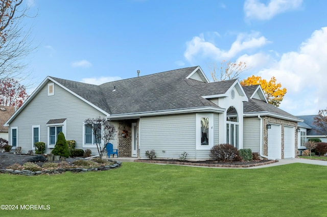 ranch-style house featuring a garage and a front lawn