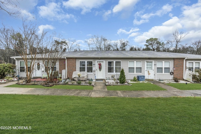 ranch-style house featuring a garage and a front yard