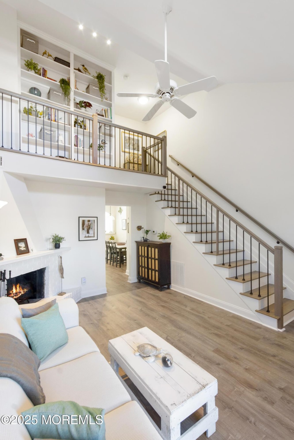 living room featuring wood-type flooring and ceiling fan