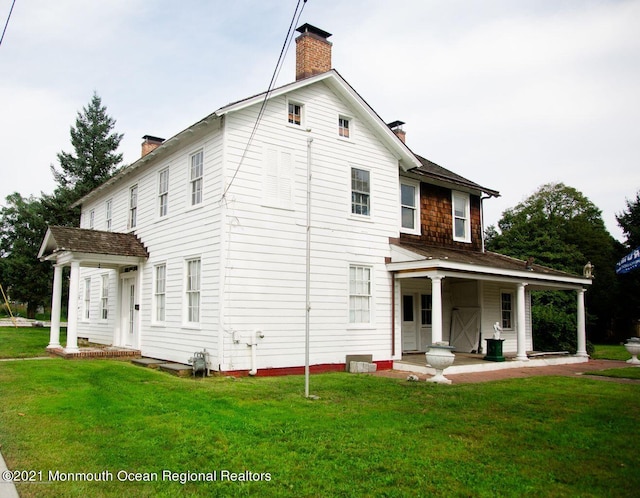 583 Cedar Ave, West Long Branch, NJ 07764 - back of house featuring a chimney, a yard, and a porch
