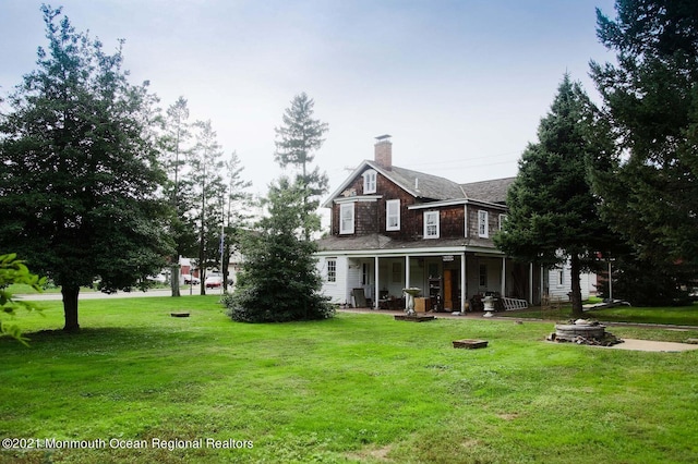 583 Cedar Ave, West Long Branch, NJ 07764 - back of house with a chimney, a lawn, and a porch
