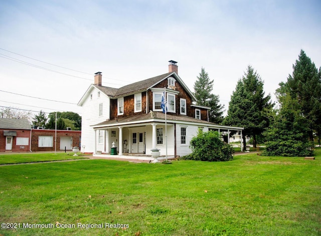 583 Cedar Ave, West Long Branch, NJ 07764 - back of property featuring covered porch, a chimney, and a yard