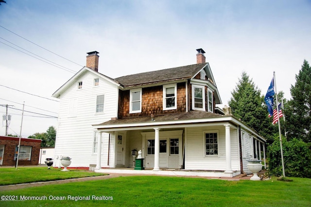 583 Cedar Ave, West Long Branch, NJ 07764 - view of front of house featuring a chimney, a front yard, and a shingled roof