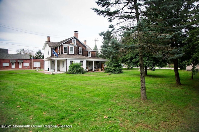 583 Cedar Ave, West Long Branch, NJ 07764 - back of house featuring a chimney, covered porch, and a lawn