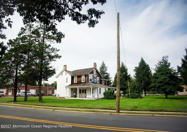 583 Cedar Ave, West Long Branch, NJ 07764 - farmhouse inspired home with a chimney, a front yard, and a porch