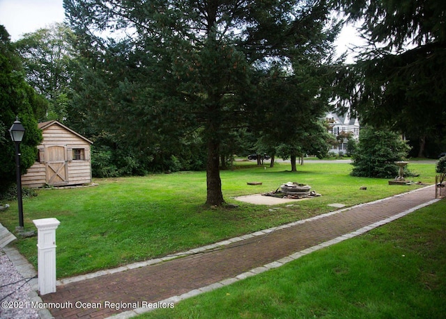 583 Cedar Ave, West Long Branch, NJ 07764 - view of property's community with an outdoor fire pit, a storage shed, and a lawn